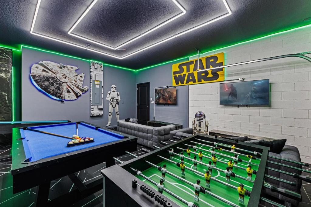 a living room with a pool table and a star wars room at 295 Marcello Blvd in Kissimmee