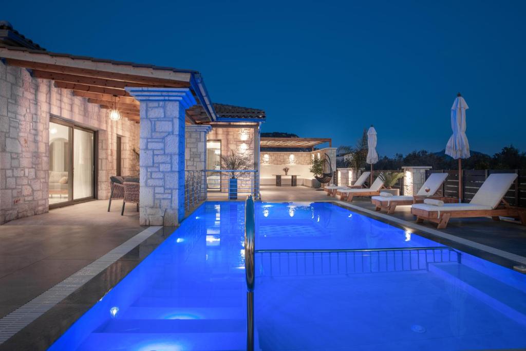 a swimming pool in a villa at night at Villa Llaha Gabrijela - Luxurious Private Escape with Pool in Nature - By Villa Mana Gers in Gaïtánion