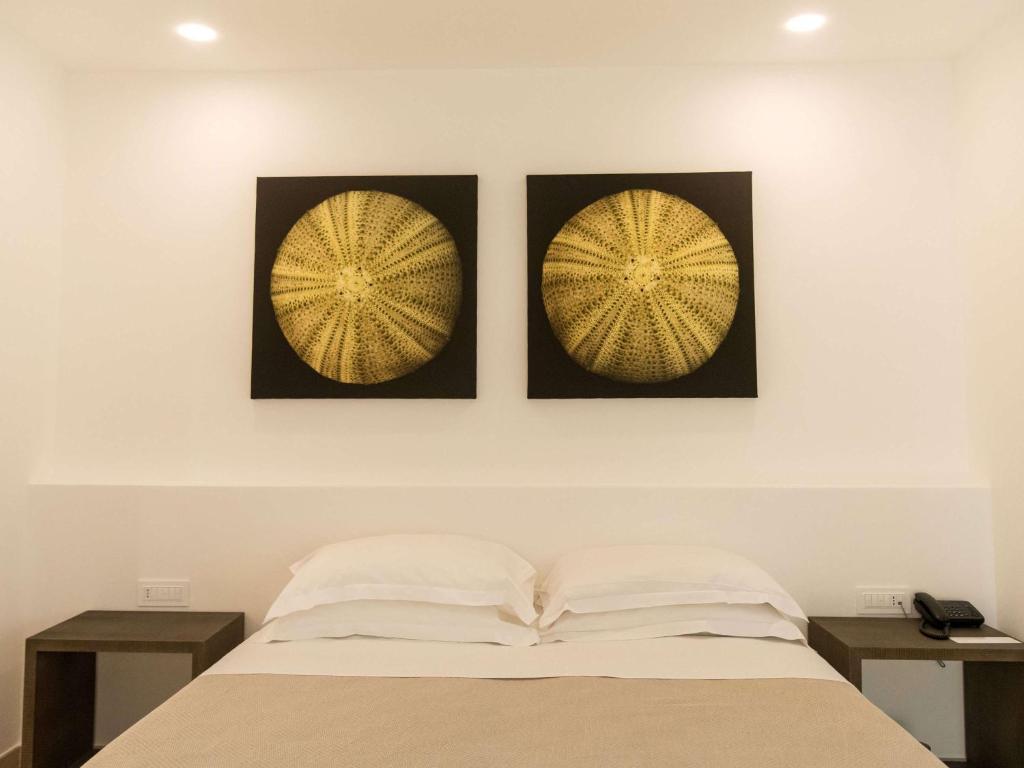 Postel nebo postele na pokoji v ubytování Hotel Baia Delle Zagare