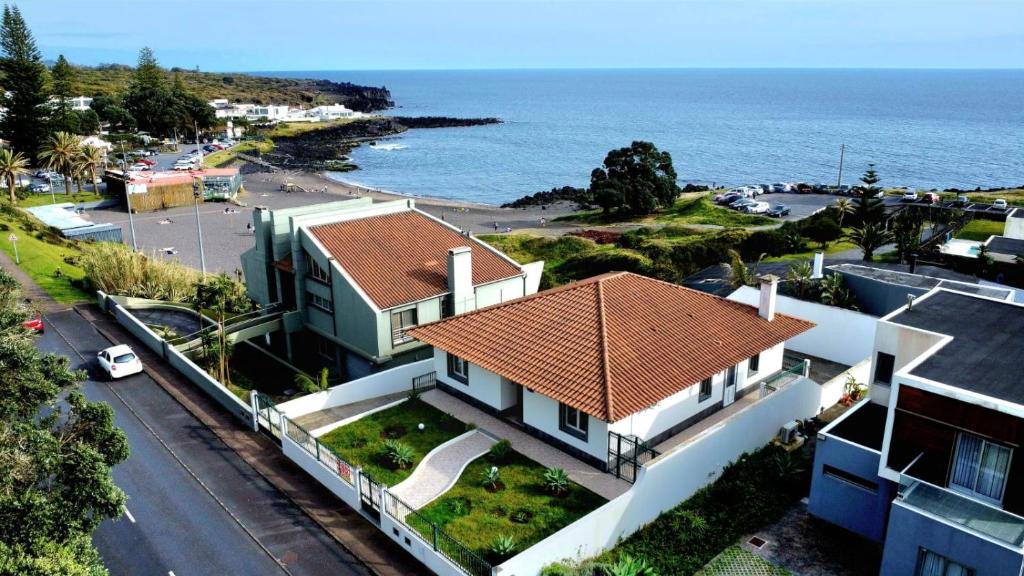 an aerial view of a house next to the ocean at Ocean Breeze in Ponta Delgada