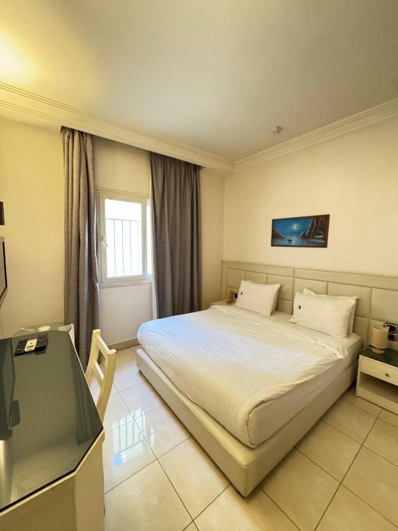 Postel nebo postele na pokoji v ubytování Ny Suites