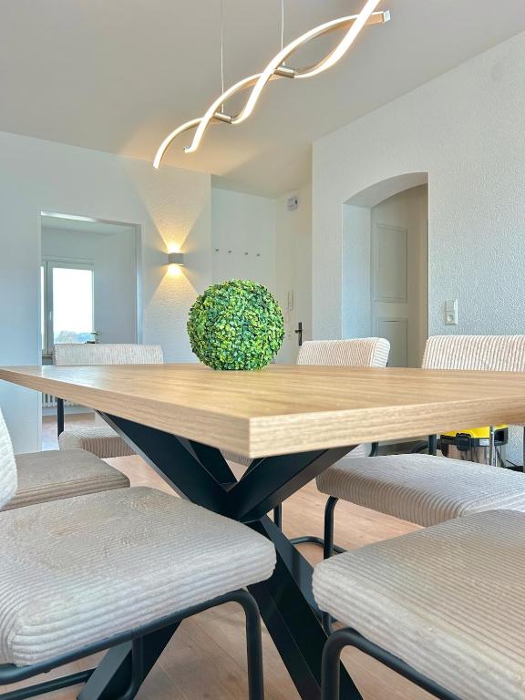a dining room with a wooden table and chairs at Basel & Frankreich nah - Airport I Parking I WLAN in Herten