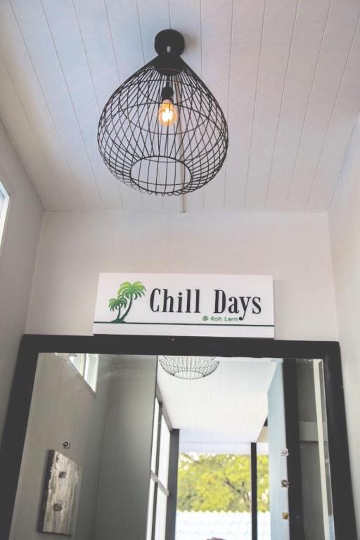 a sign that reads chill days hanging above a door at Chill Days @ Koh Larn in Ko Larn