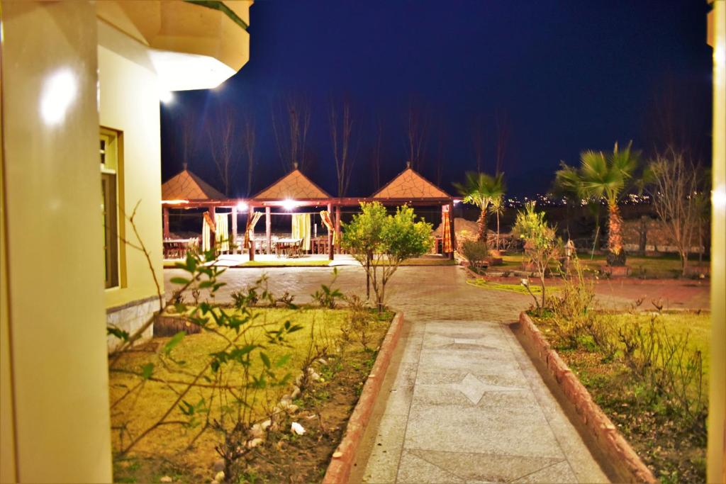 a view of a house at night with a pathway at Suvastu Resort Swat by Khan Familia Travels in Swat