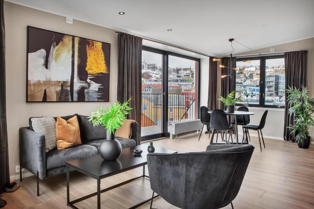 a living room with a couch and a table at TotalApartments Vervet Apartment Hotel in Tromsø