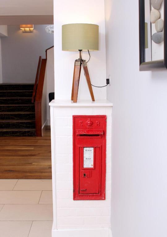 a red pillar box with a lamp on top of it at The Cliff Hotel & Spa in Cardigan