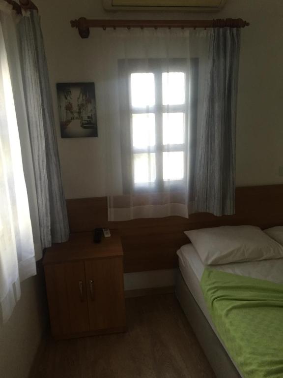 Postel nebo postele na pokoji v ubytování Tay Pansiyon