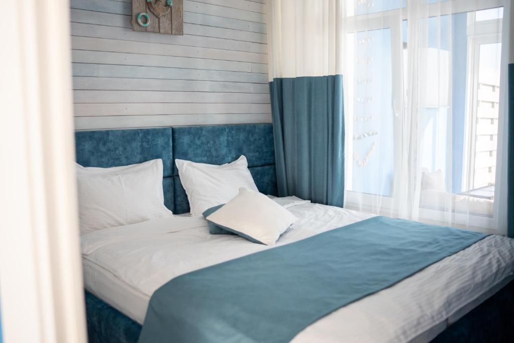 Postel nebo postele na pokoji v ubytování Apart-Hotel Poseidon