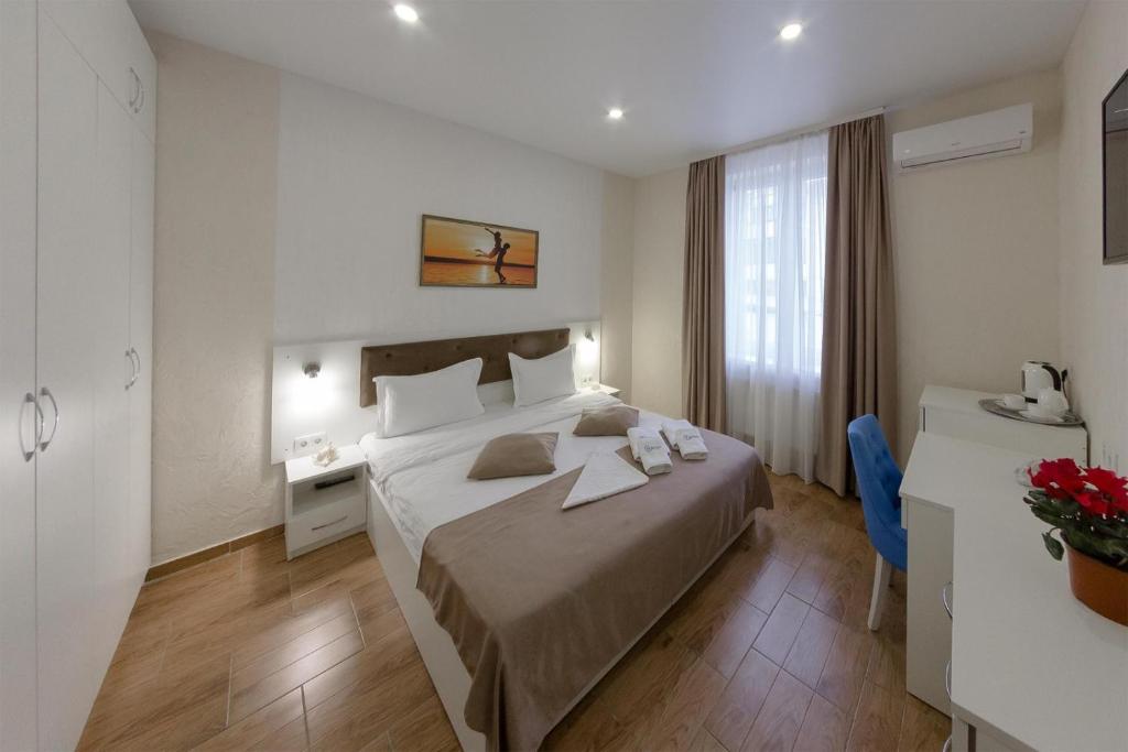 Postel nebo postele na pokoji v ubytování Apart-Hotel Poseidon
