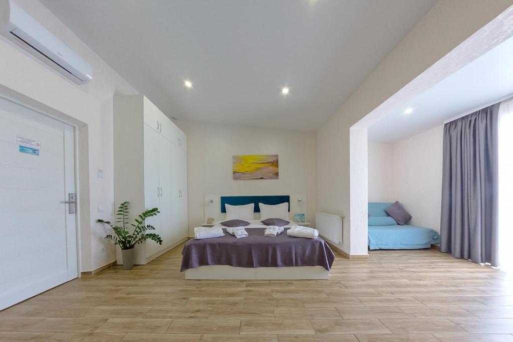 Postel nebo postele na pokoji v ubytování Apart-Hotel Poseidon