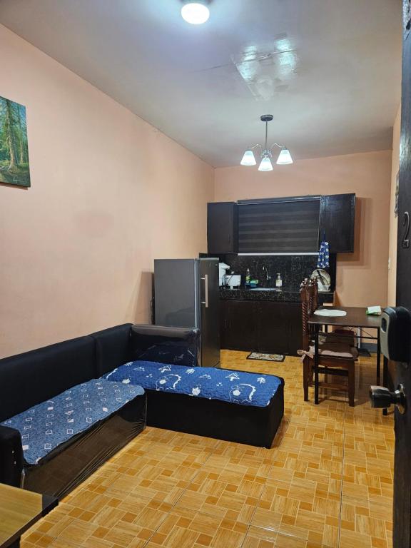 a living room with a bed and a kitchen at Mel's Place Batangas Unit 2 Two-BR House Balagtas Batangas City Free Parking, WIFI, Hot & Cold Shower in Batangas City