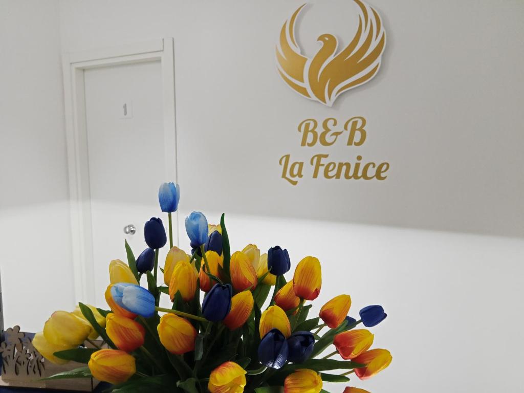 a vase filled with colorful tulips in a room at B&B La Fenice in Pompei