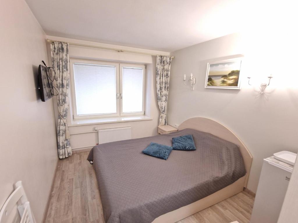 Ένα ή περισσότερα κρεβάτια σε δωμάτιο στο Girulių apartamentai prie jūros