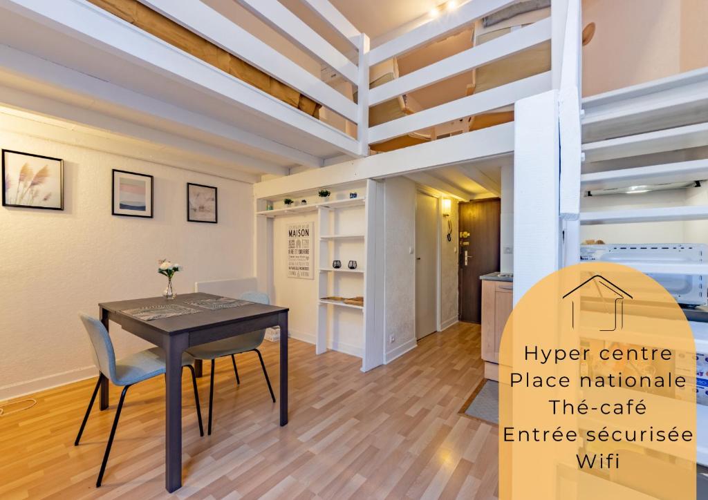 une cuisine et une salle à manger avec une table et des chaises dans l'établissement L'alcôve Grand studio, proche Place Nationale, à Montauban