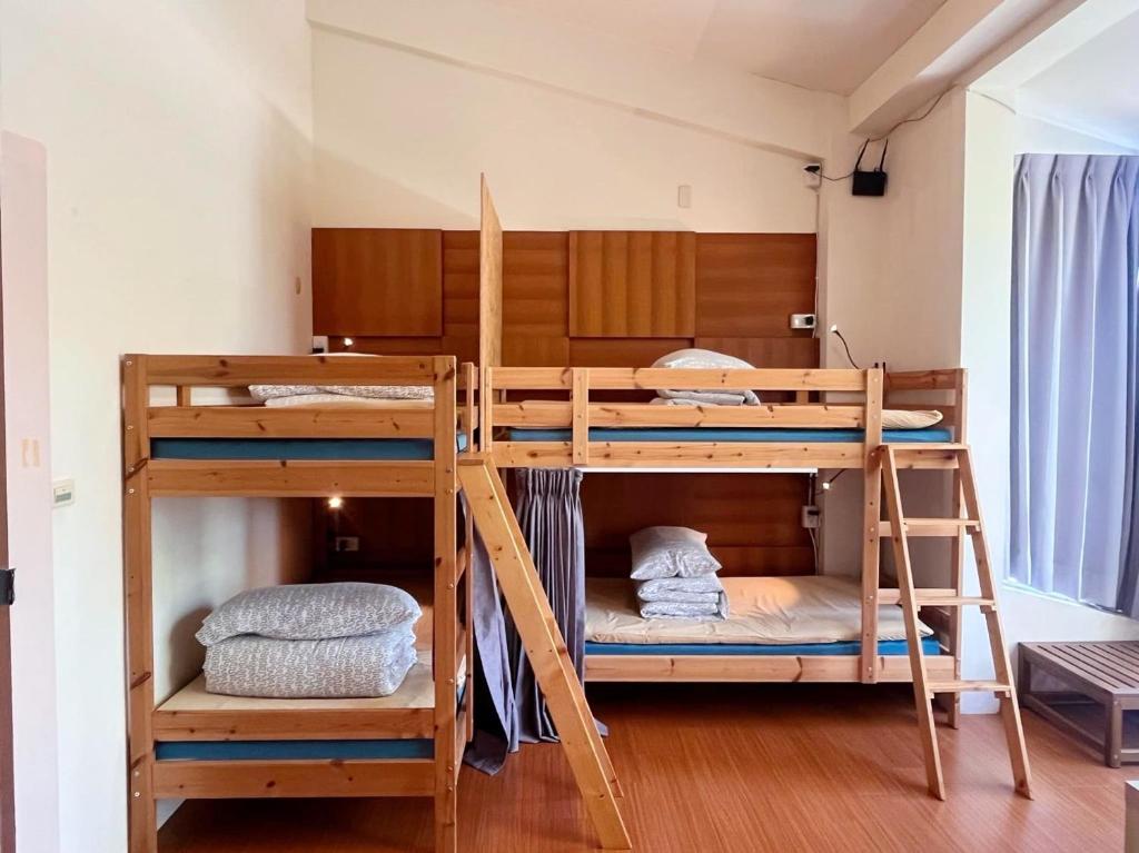 Postel nebo postele na pokoji v ubytování Miaoli Sanyi Travelling Homestay