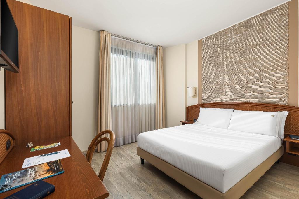 Postel nebo postele na pokoji v ubytování Welcome Hotel