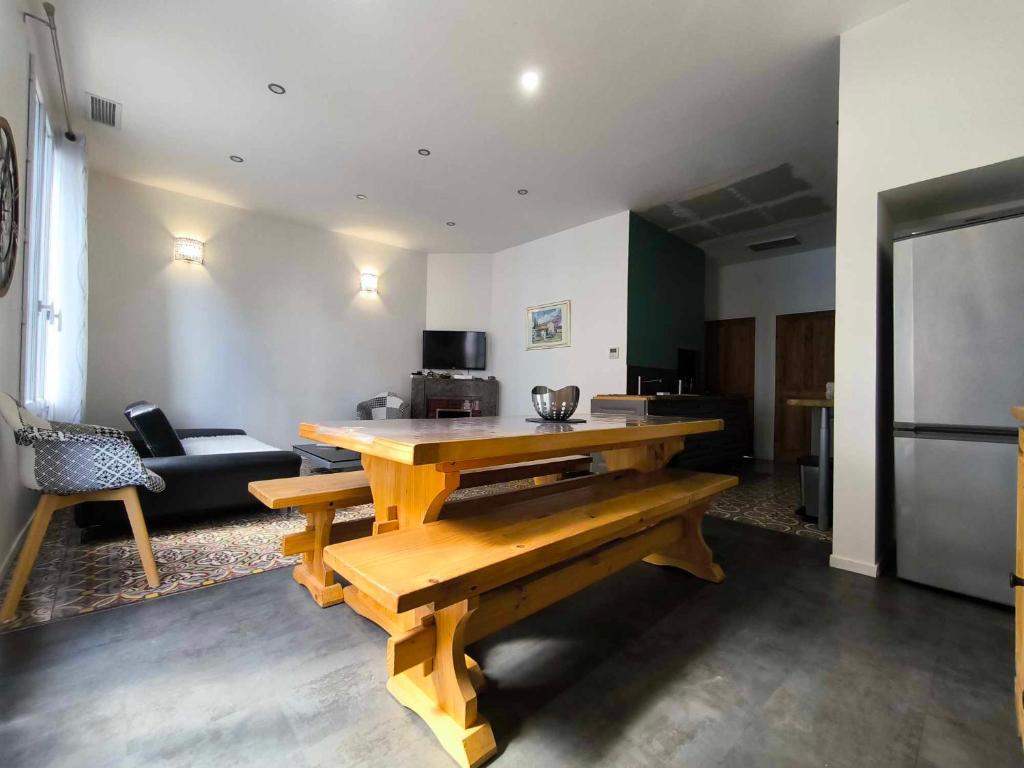 un salon avec une table en bois et un canapé dans l'établissement Appartement climatisé à deux pas des remparts, à Avignon