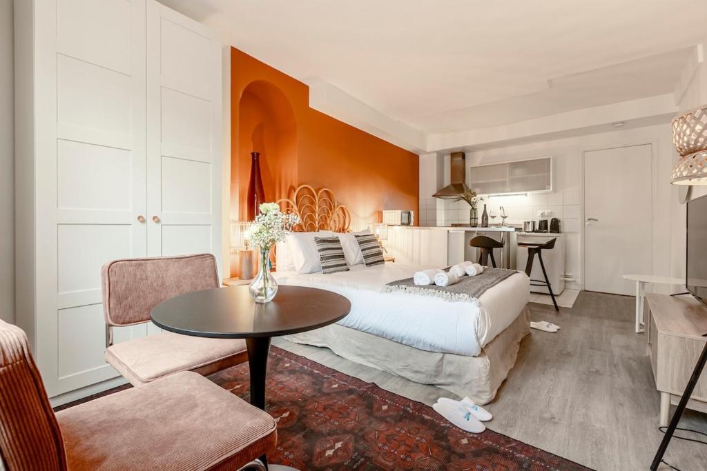 a bedroom with a bed and a table in a room at 41#Opéra #GrandsBoulevards #Studio # Paris 02 #AC in Paris