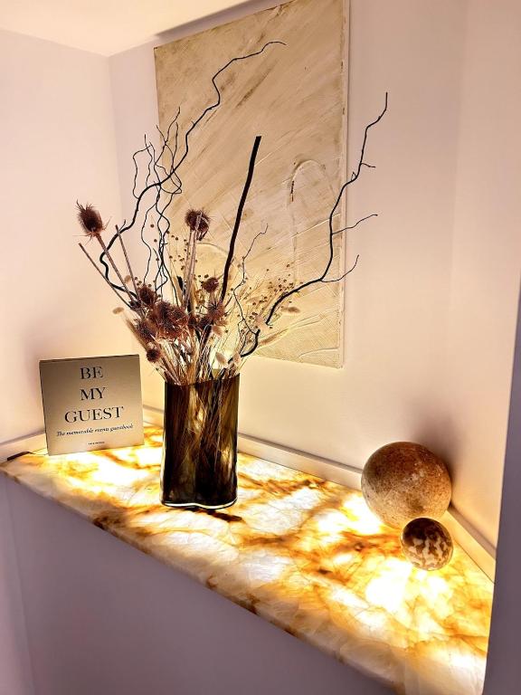 a vase with flowers in it sitting on a table at Stunning beach apartment in Almancil