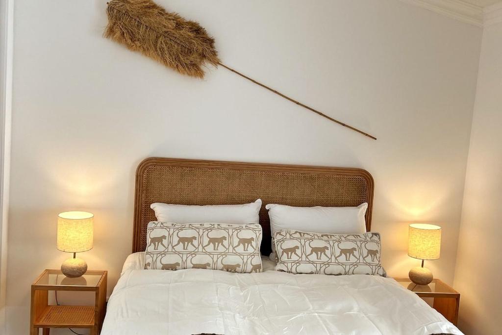 a bedroom with a white bed with two night stands at Stunning beach apartment in Almancil
