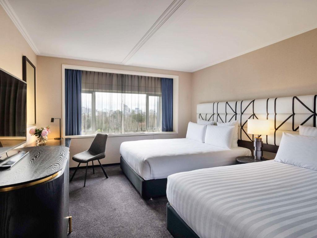 Postel nebo postele na pokoji v ubytování Pullman Auckland Hotel & Apartments