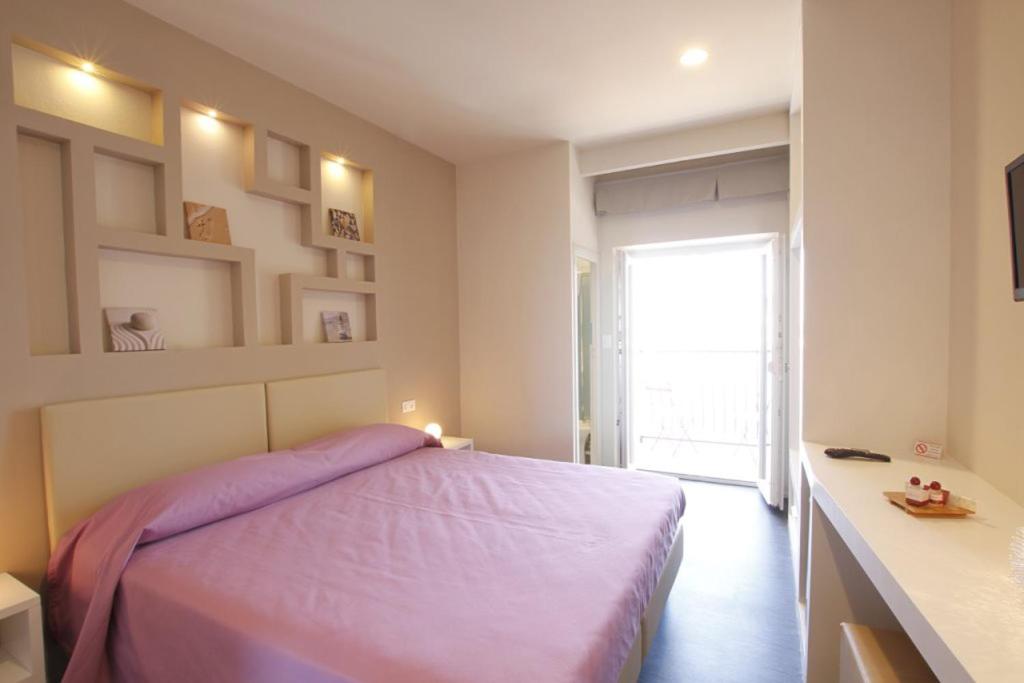 Łóżko lub łóżka w pokoju w obiekcie Hotel l'Approdo