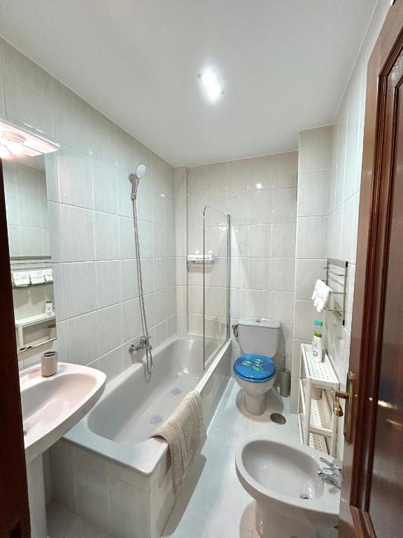 Un baño con bañera, inodoro y lavabo. en Apartamento Aqua Marina, en O Grove