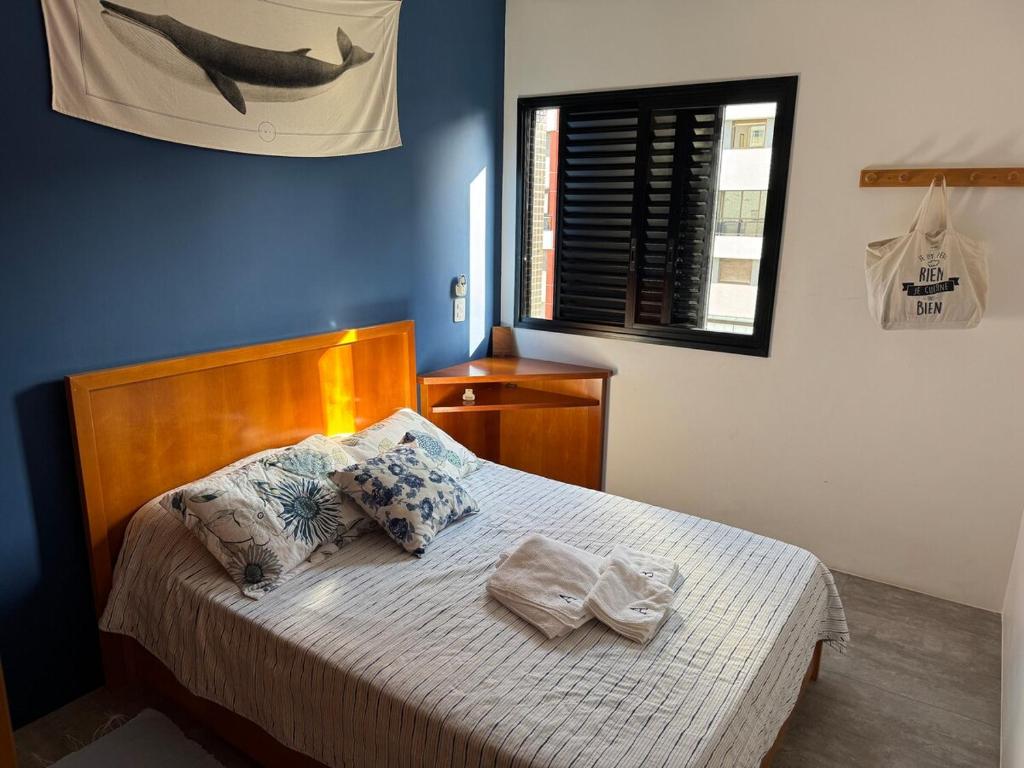 a bedroom with a bed with two towels on it at Riviera 200m Praia Serv de Praia and Pisc Aquec in Bertioga
