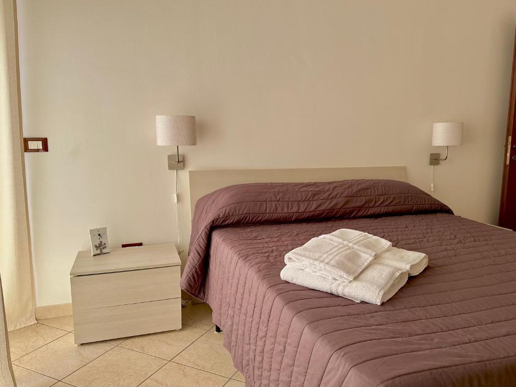 Postel nebo postele na pokoji v ubytování Appartamento Villa Circe