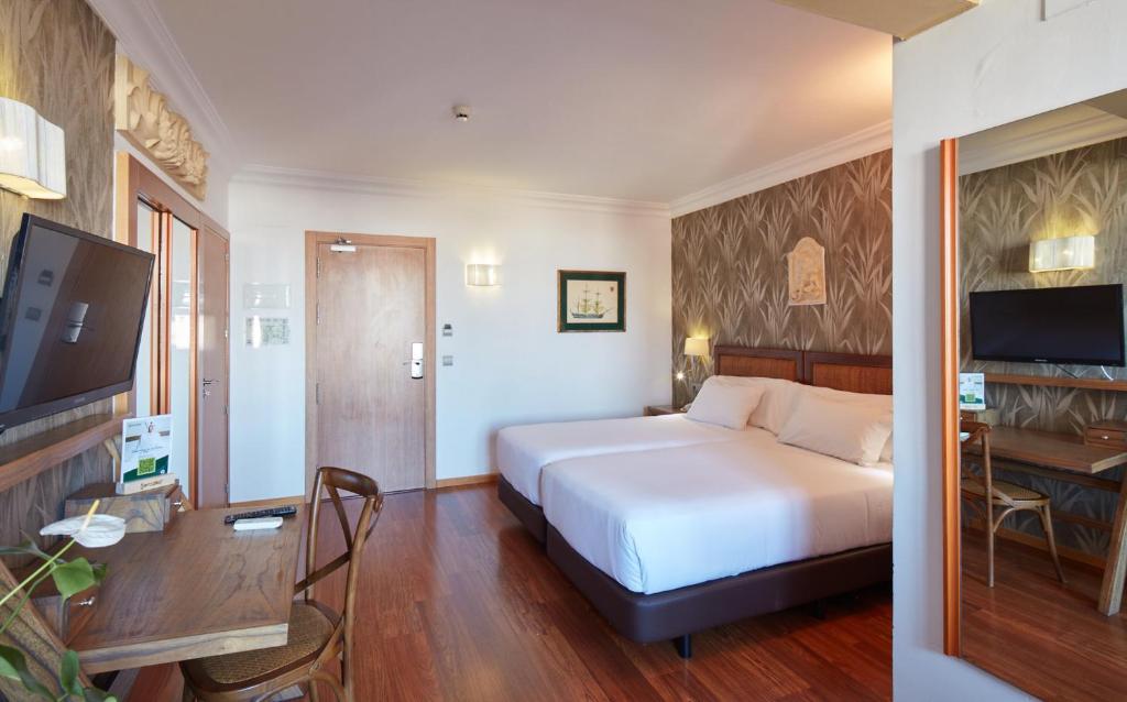 Posteľ alebo postele v izbe v ubytovaní Sercotel Hotel President