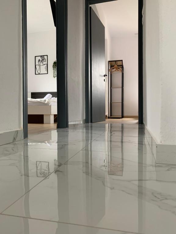 a hallway with white walls and a white floor and a door at Village Villa, Agios Georgios Grevena in Grevena