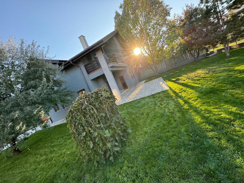 a house with a bunch of bushes in the yard at Vila Amy - 5 min from THERME and AIRPORT in Corbeanca