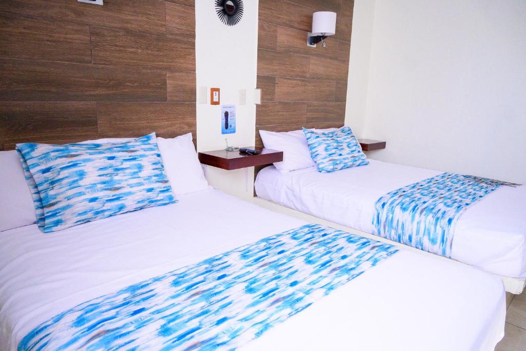 Postel nebo postele na pokoji v ubytování Hotel Acuario En Ocotlán