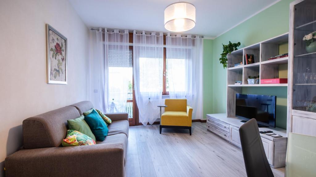 Una sala de estar con un sofá y un televisor. en Italianway - Bersaglio 25, en Udine