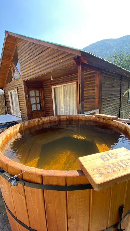 a large hot tub in front of a house at Lamoni - Cabañas con Hot Tub ilimitado y bajada al Río in Guayacán