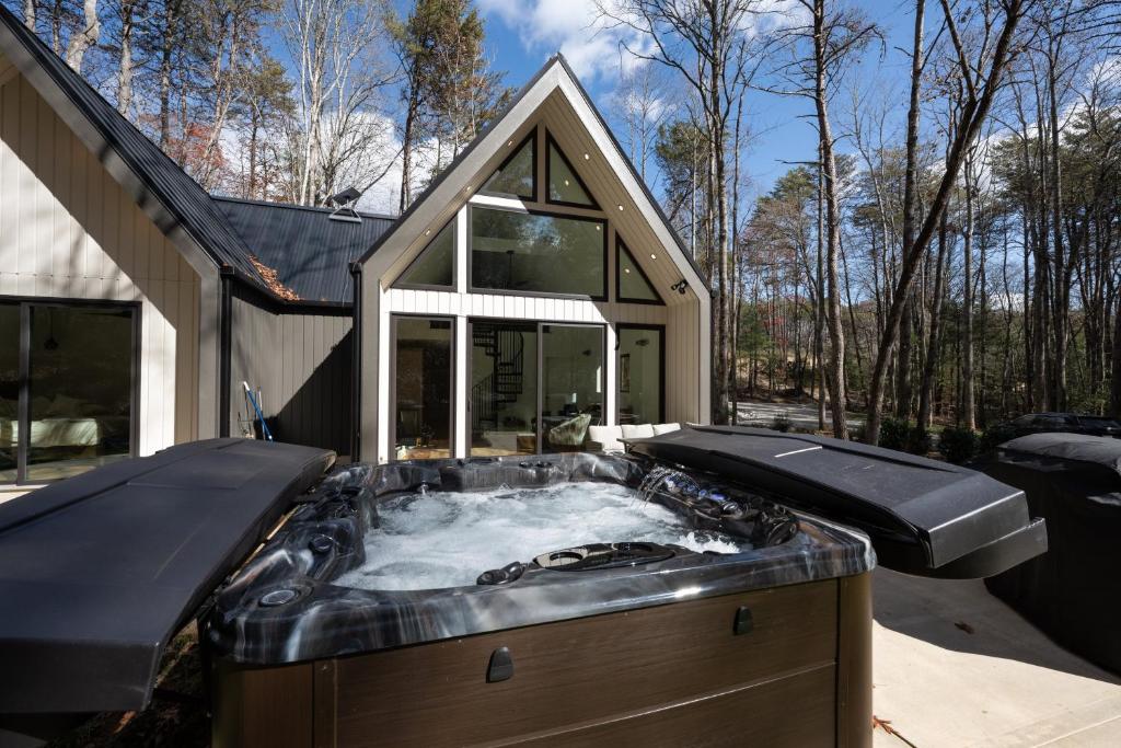 a hot tub in the backyard of a house at The Bungalow at Valley Bear Farms Resort in Balsam Grove
