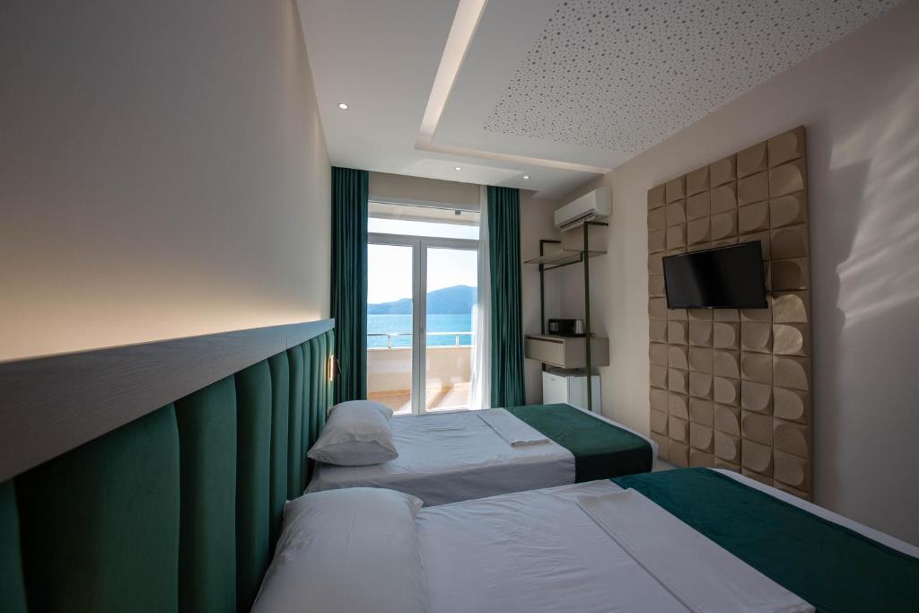 Postel nebo postele na pokoji v ubytování Hotel Royal