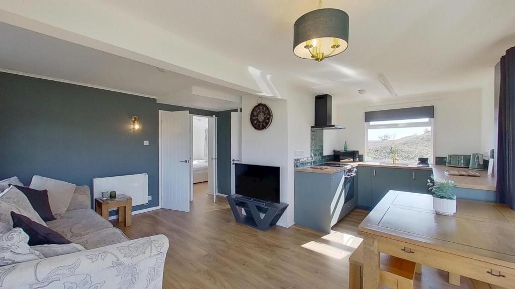 a living room and kitchen with a couch and a table at G17 St Meva, Riviere Towans in Hayle