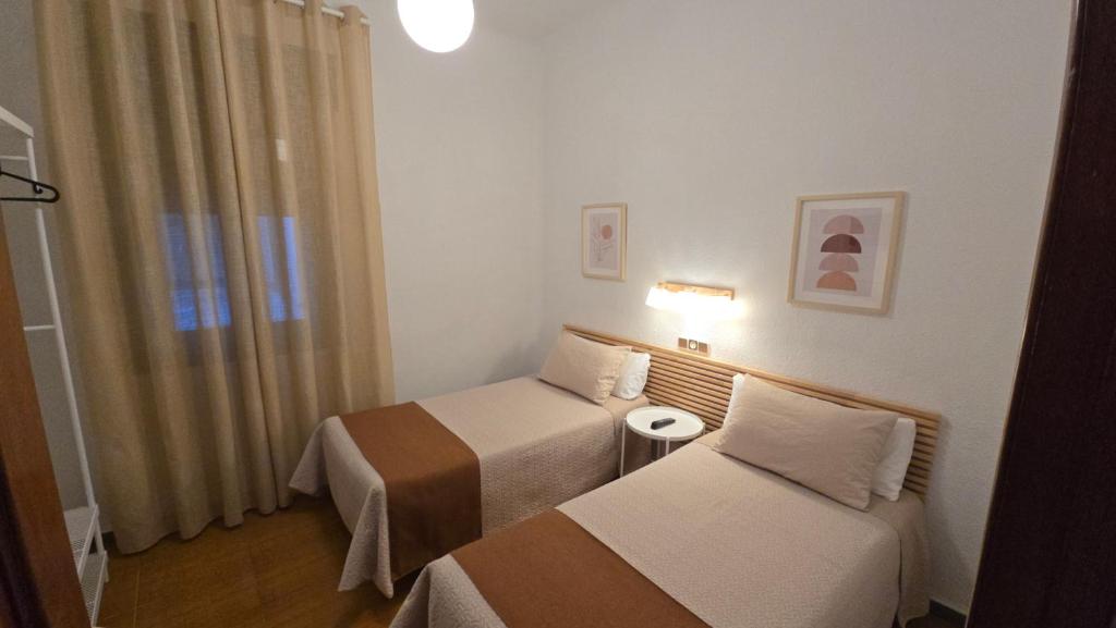 Postel nebo postele na pokoji v ubytování Hostal Prada