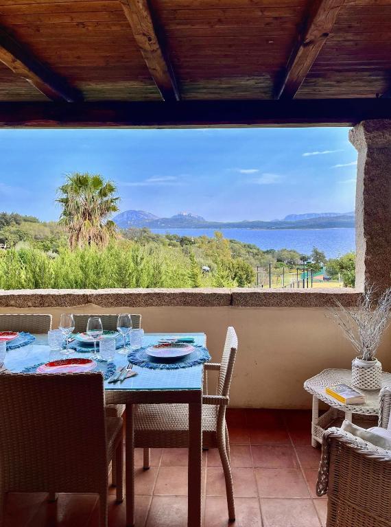 a dining room with a table and a view of the ocean at Over The Sea Punta Lada in Porto Rotondo