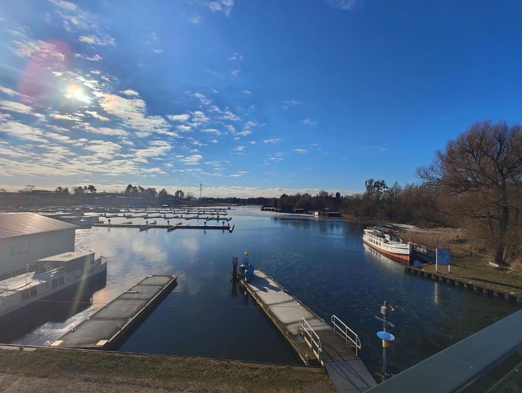 a view of a river with a dock and a boat at Marina-Penthouse 625 in Zielow