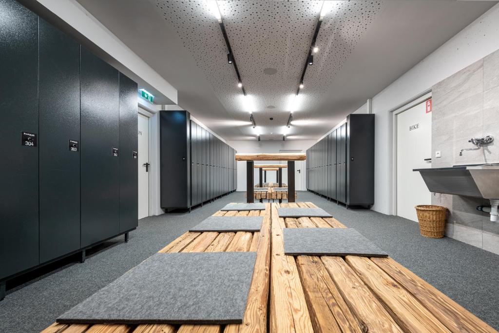 a hallway with a row of carpets in a locker room at Hotel Der Löwe LEBE FREI in Leogang