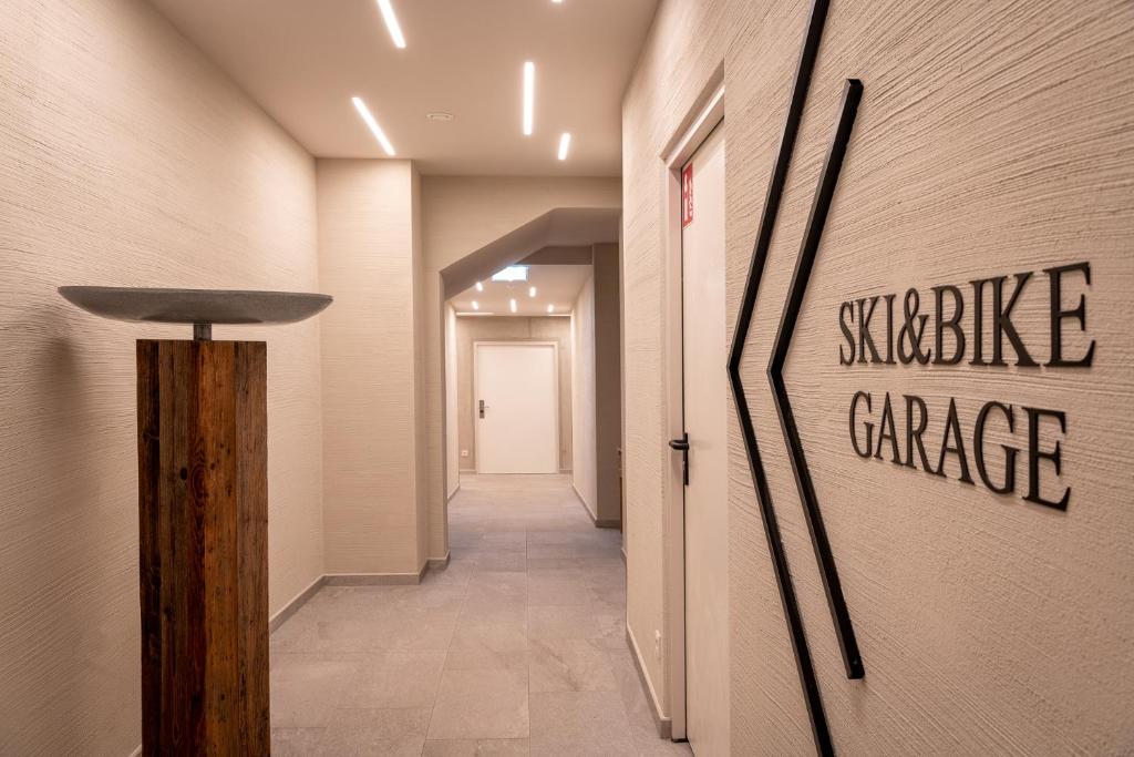 a hallway in a building with a sign on the wall at Hotel Der Löwe LEBE FREI in Leogang