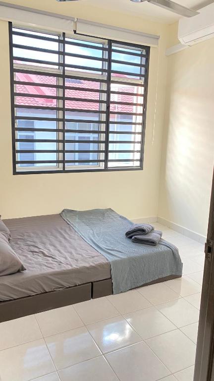 Postel nebo postele na pokoji v ubytování Assyifa Homestay Kulim