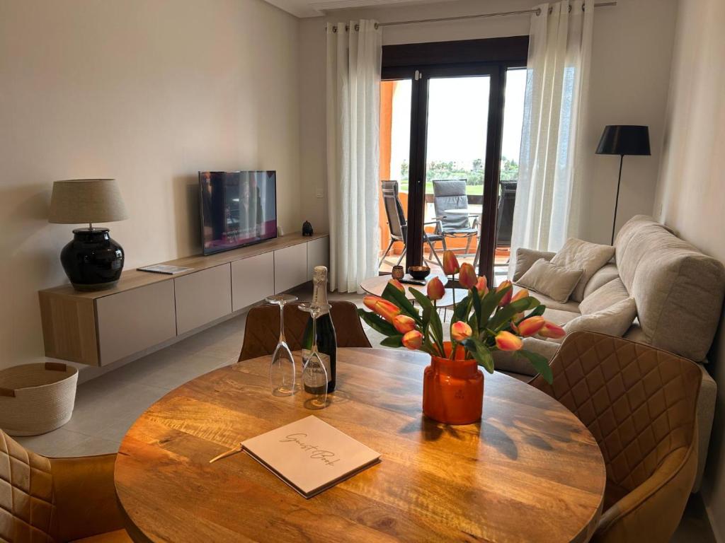 a living room with a wooden table and a couch at Casa Matthis in Los Alcázares