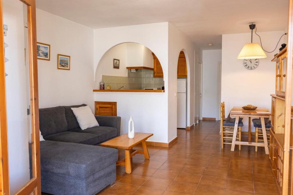 a living room with a couch and a table at Fee4Me Menorca Ideal Apartment 700m from the Sea in Arenal d'en Castell