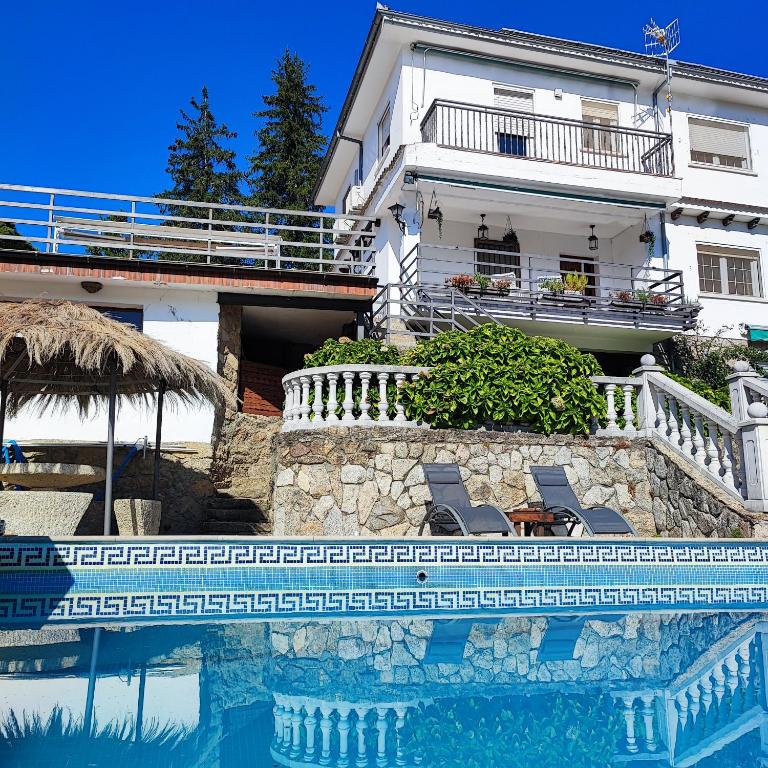 a house with a swimming pool in front of a house at Villa Moiko in La Parra