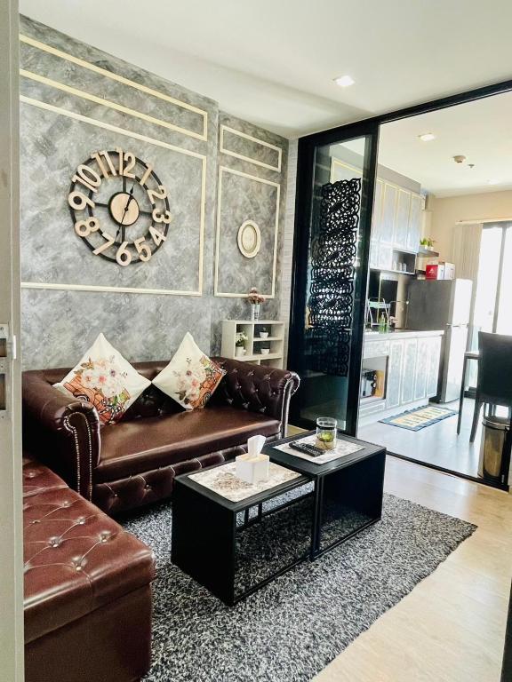 a living room with a couch and a coffee table at The base Central luxury by Numam in Pattaya