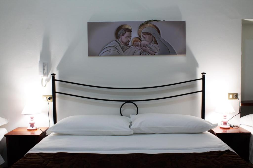 Postel nebo postele na pokoji v ubytování Hotel Il Vicoletto
