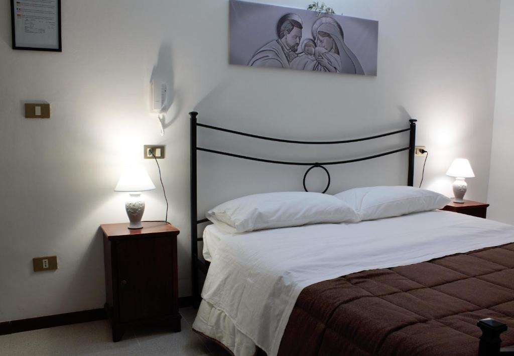 Postel nebo postele na pokoji v ubytování Hotel Il Vicoletto
